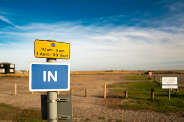 Shallow focus of the entrance to a large coastal car park in east anglia, uk. The car park is known to flood during a spring tide.