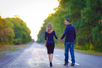 Fototapeta premium A Happy couple in love on the road in the park on nature travel