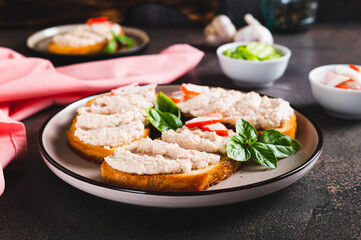Crab stick and cucumber pate on toast on a plate on the table