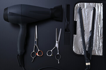 hair dryer, hair straightener, comb and hairdresser scissors close-up