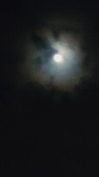 Full moon night. Black sky with moon light through flowing clouds. Halloween design. Horror cinema mood. Vampires and werewolves, scary tales. Spooky season. Dark nature background video. Creepy vibe