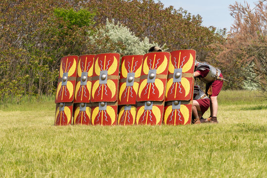 Roman legionaries in testudo formation with red shields