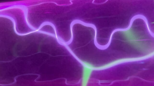 Pink gas electric discharge in transparent glass tube