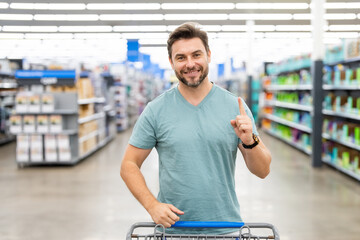 Man shopper with shopping cart. Shop idea. Impulse purchases. Random purchase. Man purchases made without a specific plan or intention, often driven by spontaneity or chance. Purchase order.