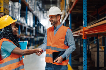 Warehouse workers shaking hands after reaching agreement