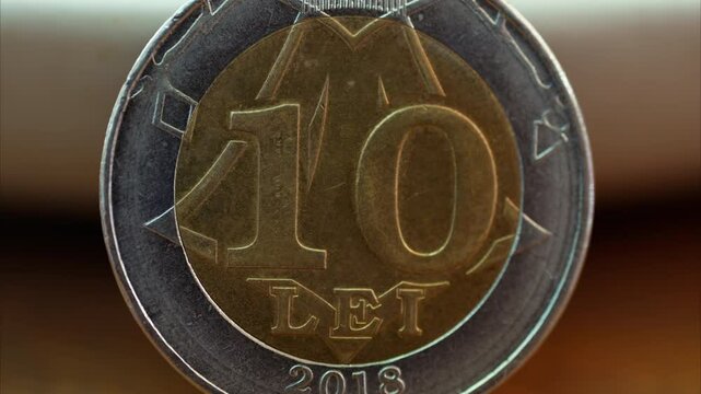 Close up of a 10 lei mdl coin on a wooden surface