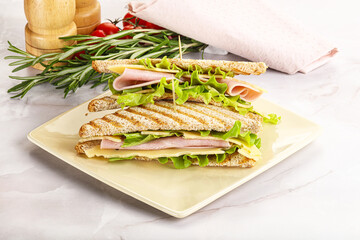 Homemade club sandwich with ham and cheese