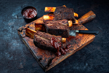 Traditional barbecue burnt chuck beef ribs marinated with spicy rub and served as close-up on an...