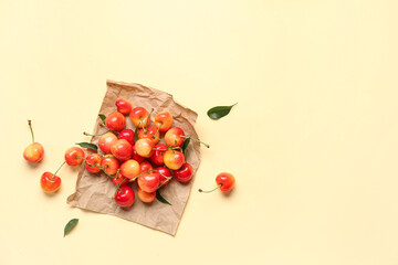 Paper with sweet cherries on light background