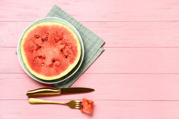 Plate with slice of fresh watermelon on pink wooden background