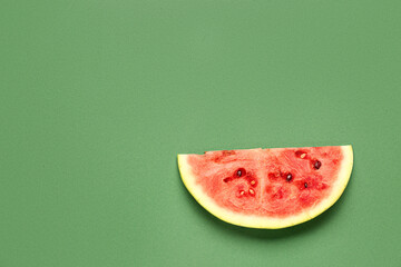 Piece of fresh watermelon on green background