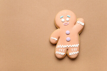 Tasty gingerbread man on color background
