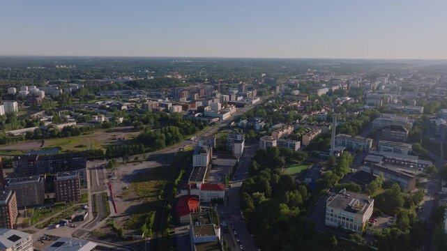 Aerial view of Turku, Finland showcasing a mix of urban development and green areas. The camera pans smoothly across the cityscape, capturing the essence of this historic city