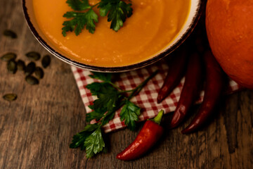 Pumpkin soup in a bowl on the table. Autumn healthy food. Ingathering