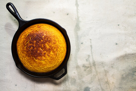 Corn cake cooked in a cast iron skillet on a table