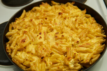 Golden-brown casserole of macaroni and cheese, bubbling with cheesy goodness