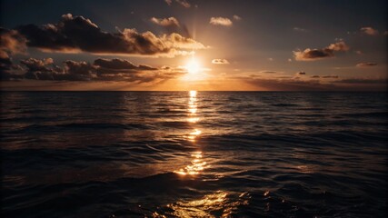 Obraz premium Sunset over ocean with golden reflection and tranquil seascape.