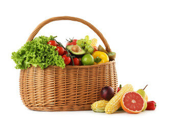 Different fresh vegetables and fruits in wicker basket isolated on white