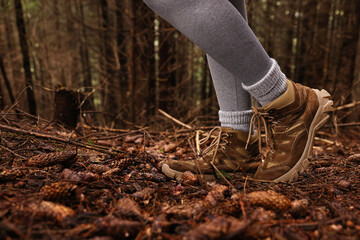 Fototapeta premium Hiker with trekking shoes in forest, closeup