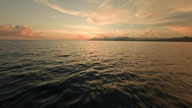 hang glider flying over the sea at sunset drone shot. High quality 4k footage high flying beautiful view of the coast