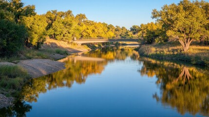 Bridge Over a River with Autumn Trees Reflecting in the Water