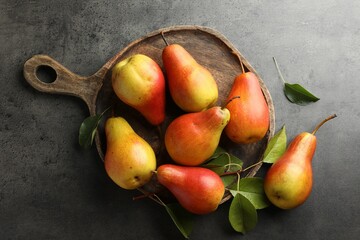 Ripe juicy pears on grey table, flat lay