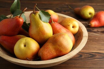 Ripe juicy pears on wooden table, closeup