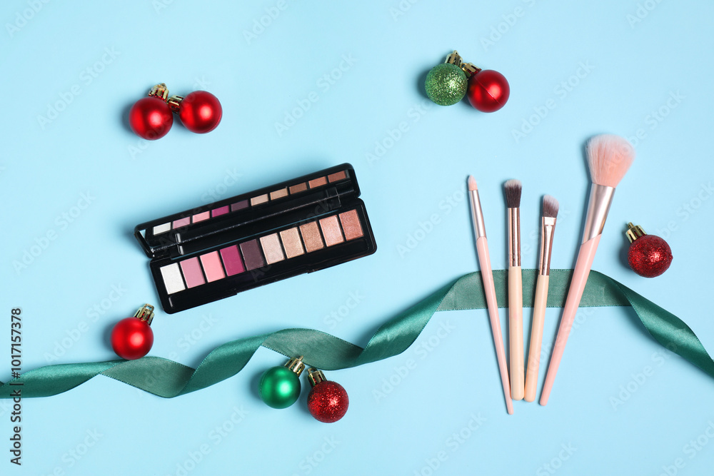 Canvas Prints Flat lay composition with makeup products and Christmas decor on light blue background