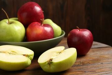 Fresh red and green apples on wooden table, closeup