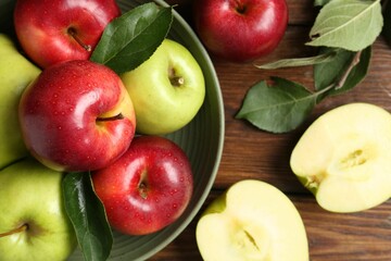 Fresh red and green apples on wooden table, flat lay