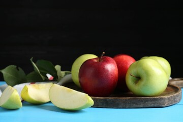 Fresh red and green apples on light blue wooden table