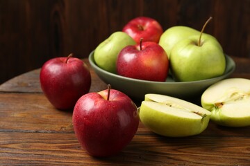Fresh red and green apples on wooden table