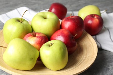 Fresh red and green apples on grey table, closeup