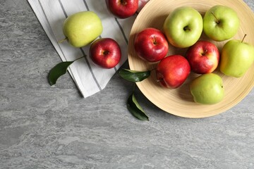 Fresh red and green apples on grey table, flat lay. Space for text