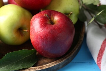 Fresh red and green apples on light blue wooden table, closeup