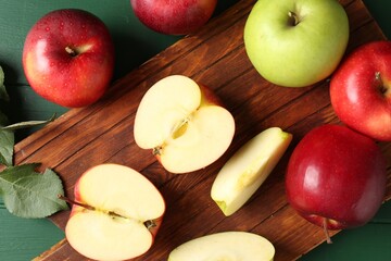 Fresh ripe apples on green wooden table, flat lay