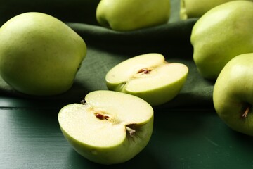 Ripe apples on green wooden table, closeup