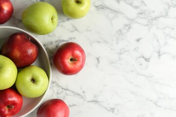 Ripe red and green apples on white marble table, top view. Space for text