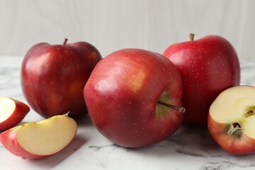 Ripe red apples on white marble table, closeup