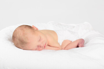Newborn baby boy in hospital cot