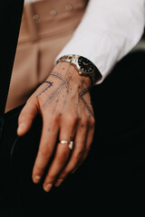 Close up of a beautifully adorned female hand showcasing intricate Turkish henna designs.