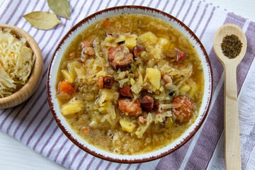 Kapuśniak - homemade, traditional Polish soup made of sauerkraut with potatoes, bacon and sausage