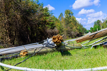 During violent hurricane, electric poles with broken wires crashed down