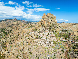 Mountains and Olive groves around Ghost Town from a drone, Pentedattilo Village, Calabria, Italy, Europe