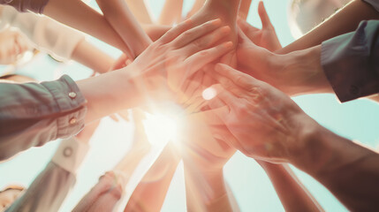 Staff's hands come together showing inspiring teamwork and unity. Coworkers showcasing shared goals and cooperative spirits as example of support, collaboration and solidarity