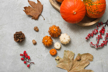 Composition with different candles, pumpkins and autumn decor on grunge background
