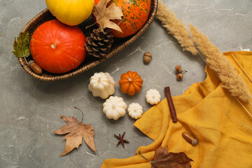 Beautiful composition with candles, ripe pumpkins and autumn decor on grunge background