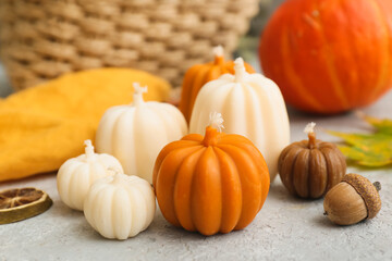 Beautiful autumn candles in shape of pumpkins on light table