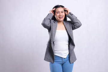 gesture beautiful young office ladies asia pain headache both hands hold head wearing gray suit standing isolated on white background. for health, medical, commercial, prevention content