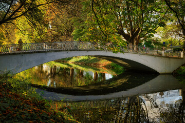 autumnal mood at the curved pedestrian bridge on the clarenbach canal in the lindenthal district of cologne
